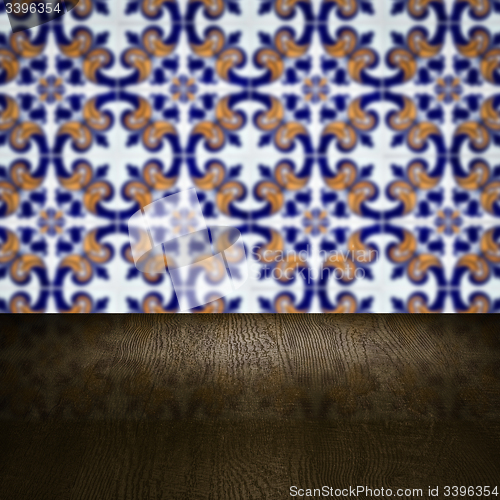 Image of Wood table top and blur vintage ceramic tile pattern wall