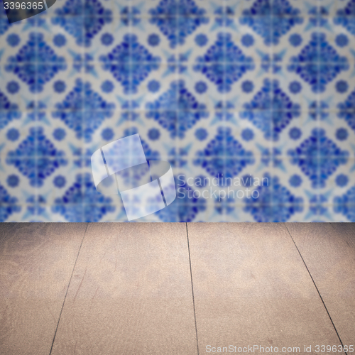 Image of Wood table top and blur vintage ceramic tile pattern wall