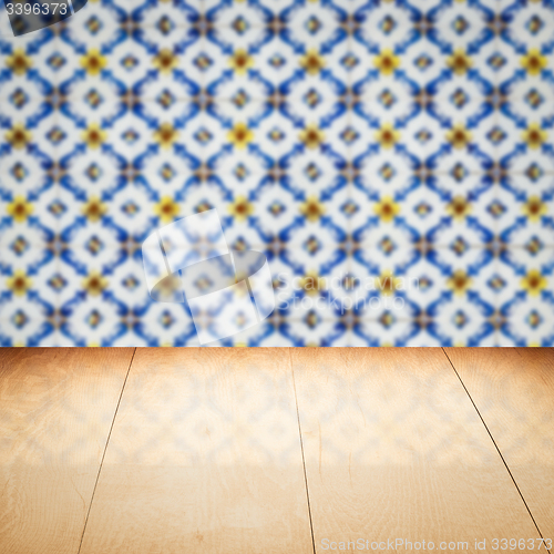 Image of Wood table top and blur vintage ceramic tile pattern wall