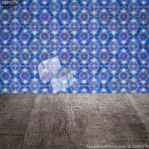 Image of Wood table top and blur vintage ceramic tile pattern wall