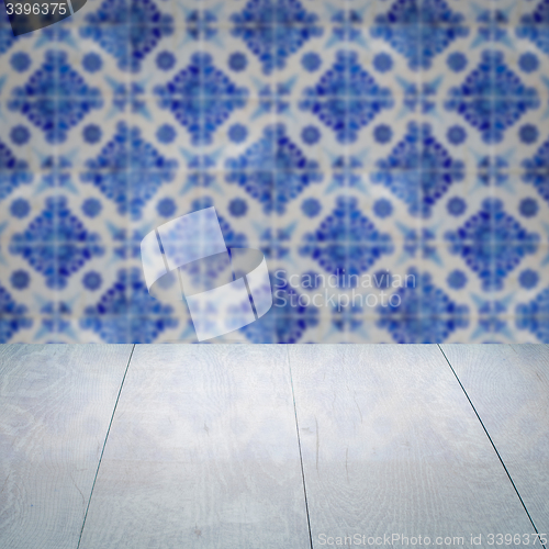 Image of Wood table top and blur vintage ceramic tile pattern wall