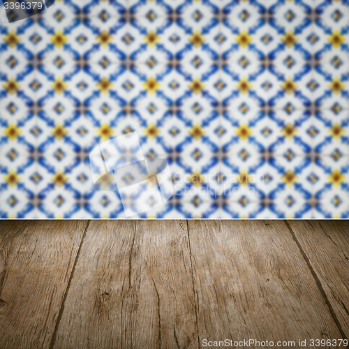 Image of Wood table top and blur vintage ceramic tile pattern wall