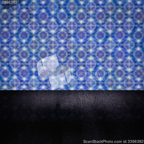 Image of Wood table top and blur vintage ceramic tile pattern wall