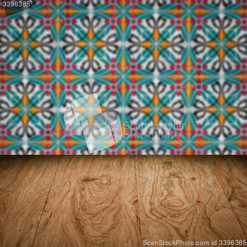 Image of Wood table top and blur vintage ceramic tile pattern wall