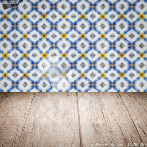 Image of Wood table top and blur vintage ceramic tile pattern wall