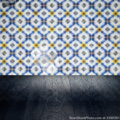 Image of Wood table top and blur vintage ceramic tile pattern wall