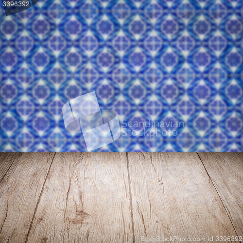 Image of Wood table top and blur vintage ceramic tile pattern wall