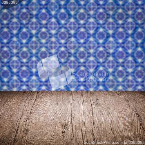 Image of Wood table top and blur vintage ceramic tile pattern wall