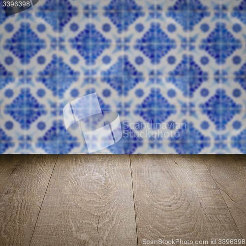 Image of Wood table top and blur vintage ceramic tile pattern wall