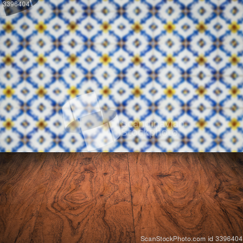 Image of Wood table top and blur vintage ceramic tile pattern wall