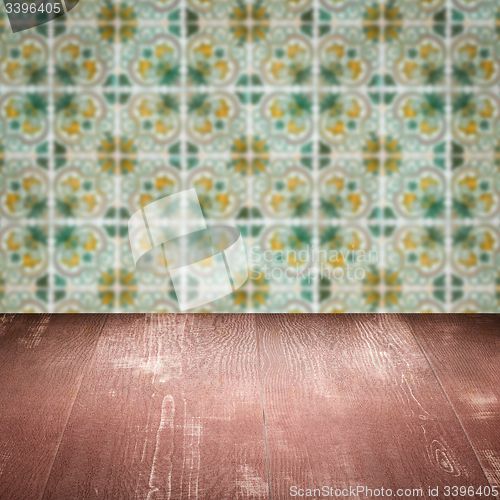 Image of Wood table top and blur vintage ceramic tile pattern wall