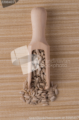 Image of Wooden scoop with shelled sunflower seeds