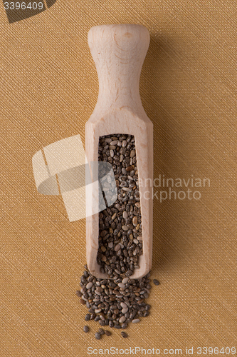 Image of Wooden scoop with chia seeds