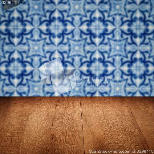 Image of Wood table top and blur vintage ceramic tile pattern wall