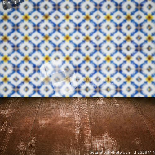 Image of Wood table top and blur vintage ceramic tile pattern wall
