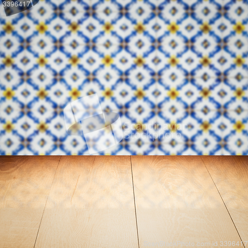 Image of Wood table top and blur vintage ceramic tile pattern wall