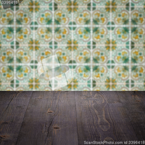 Image of Wood table top and blur vintage ceramic tile pattern wall
