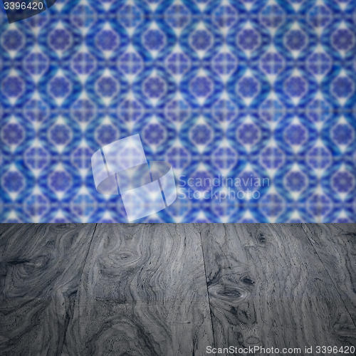 Image of Wood table top and blur vintage ceramic tile pattern wall