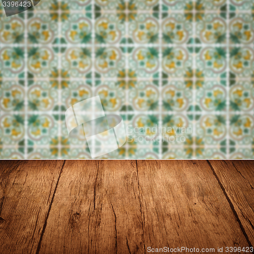 Image of Wood table top and blur vintage ceramic tile pattern wall
