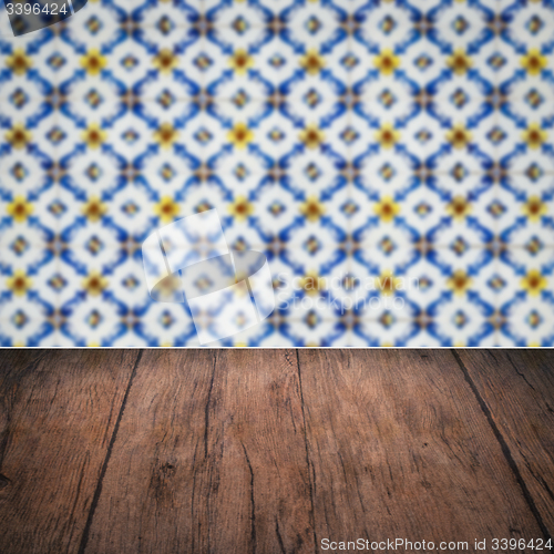 Image of Wood table top and blur vintage ceramic tile pattern wall