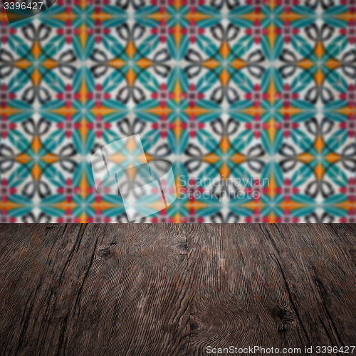 Image of Wood table top and blur vintage ceramic tile pattern wall