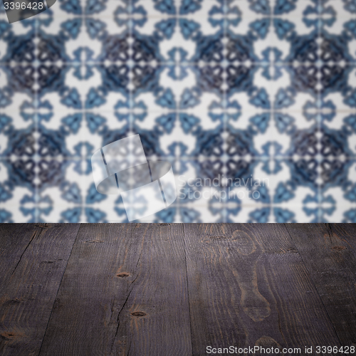 Image of Wood table top and blur vintage ceramic tile pattern wall
