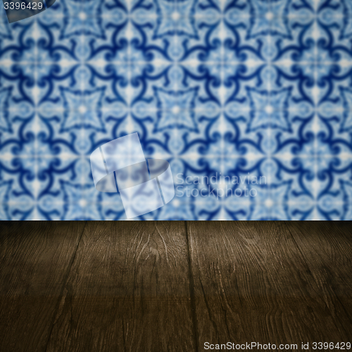 Image of Wood table top and blur vintage ceramic tile pattern wall