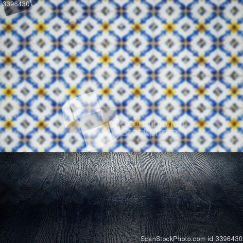 Image of Wood table top and blur vintage ceramic tile pattern wall