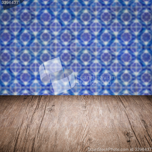 Image of Wood table top and blur vintage ceramic tile pattern wall