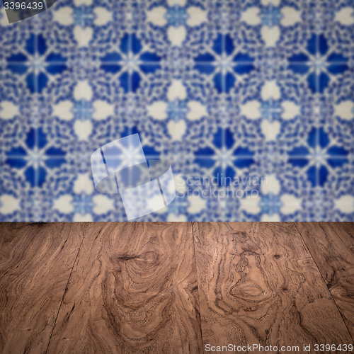 Image of Wood table top and blur vintage ceramic tile pattern wall