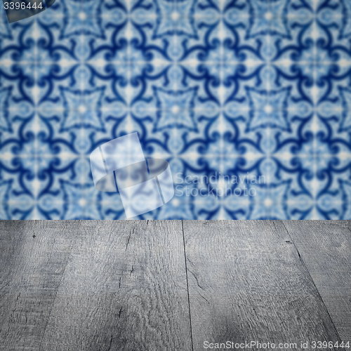 Image of Wood table top and blur vintage ceramic tile pattern wall