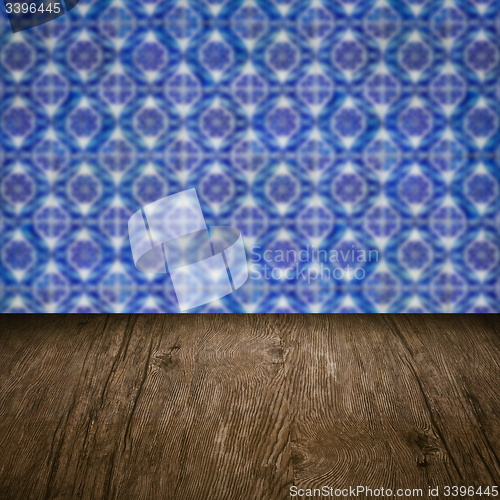 Image of Wood table top and blur vintage ceramic tile pattern wall