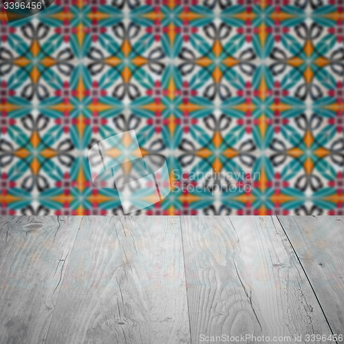 Image of Wood table top and blur vintage ceramic tile pattern wall