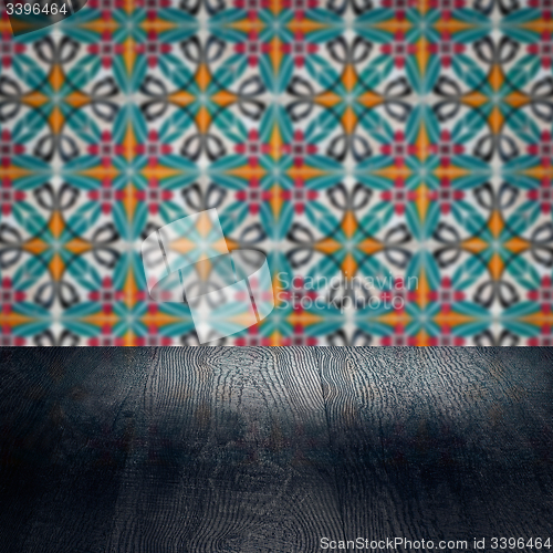 Image of Wood table top and blur vintage ceramic tile pattern wall