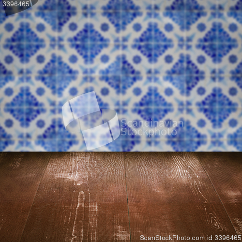 Image of Wood table top and blur vintage ceramic tile pattern wall