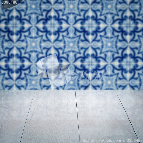 Image of Wood table top and blur vintage ceramic tile pattern wall