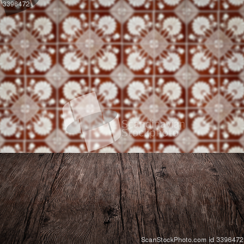 Image of Wood table top and blur vintage ceramic tile pattern wall