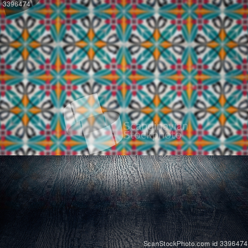 Image of Wood table top and blur vintage ceramic tile pattern wall