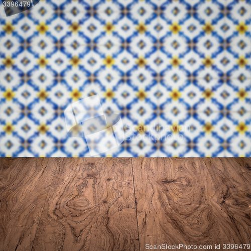 Image of Wood table top and blur vintage ceramic tile pattern wall