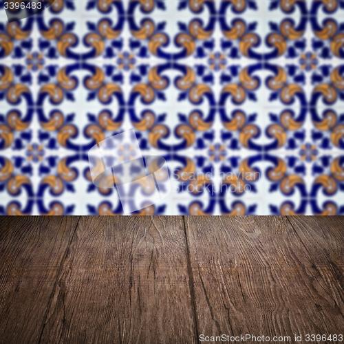 Image of Wood table top and blur vintage ceramic tile pattern wall