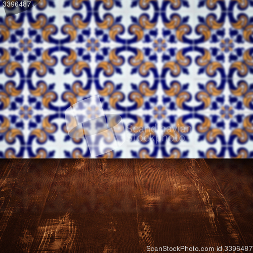 Image of Wood table top and blur vintage ceramic tile pattern wall