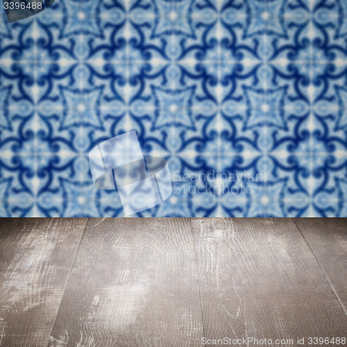 Image of Wood table top and blur vintage ceramic tile pattern wall