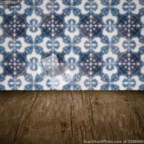 Image of Wood table top and blur vintage ceramic tile pattern wall
