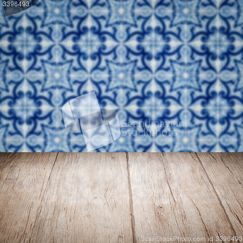 Image of Wood table top and blur vintage ceramic tile pattern wall