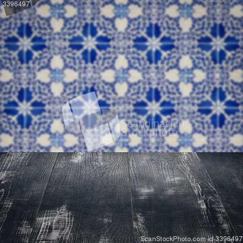 Image of Wood table top and blur vintage ceramic tile pattern wall