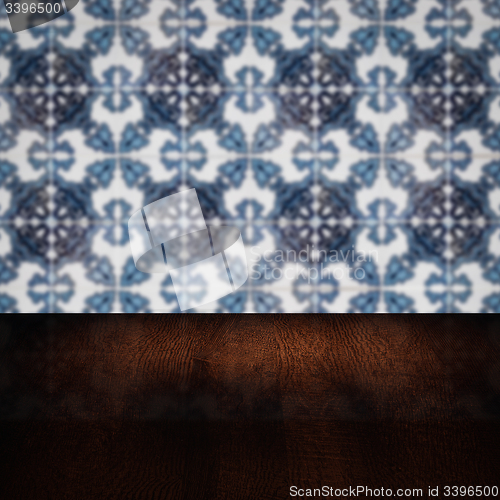 Image of Wood table top and blur vintage ceramic tile pattern wall