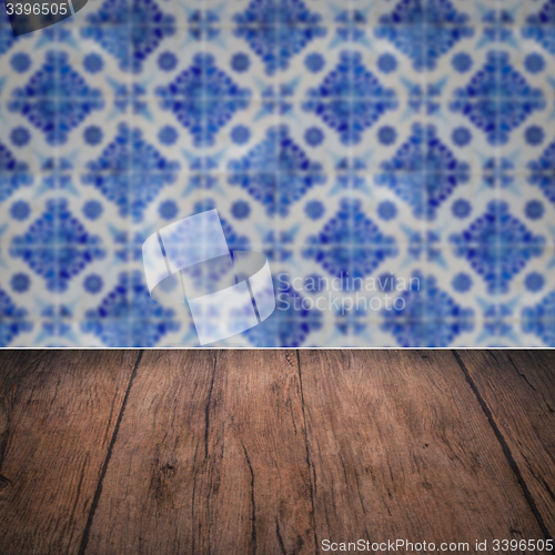 Image of Wood table top and blur vintage ceramic tile pattern wall