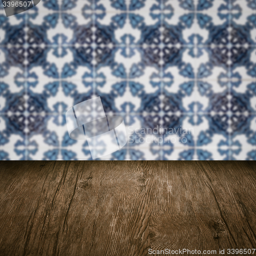Image of Wood table top and blur vintage ceramic tile pattern wall