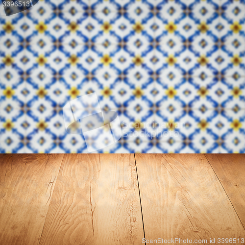 Image of Wood table top and blur vintage ceramic tile pattern wall