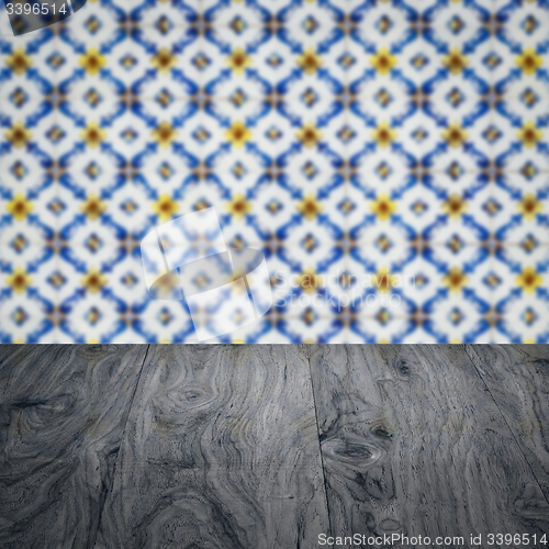 Image of Wood table top and blur vintage ceramic tile pattern wall